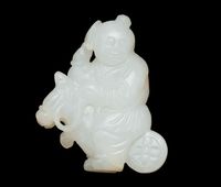 A WHITE JADE CARVING OF A BOY AND HOBBY HORSE