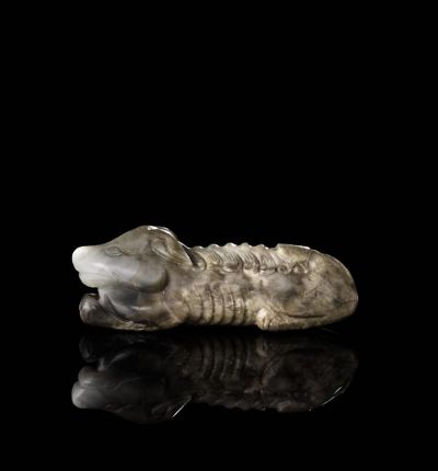 MING DYNASTY A BROWN AND GREY JADE CARVING OF A HOUND
