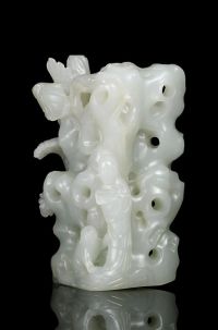 QIANLONG PERIOD A CELADON JADE CARVING OF A LADY AND CAT