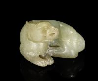 TANG DYNASTY A PALE CELADON JADE CARVING OF A MYTHICAL BEAST