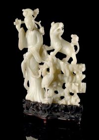 19TH CENTURY A PALE CELADON JADE LADY AND LION GROUP