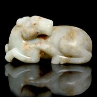 17TH CENTURY A CELADON AND RUSSET JADE CARVING OF A HORSE