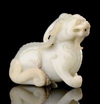 20TH CENTURY A CELADON JADE QILIN