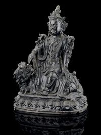 MING DYNASTY A BRONZE MODEL OF MANJUSRI