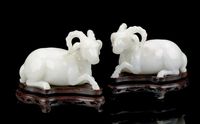 20TH CENTURY A PAIR OF WHITE JADEITE MODELS OF RAMS