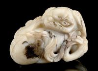 18TH CENTURY A CREAM AND BLACK JADE BUDDHISTIC LION GROUP